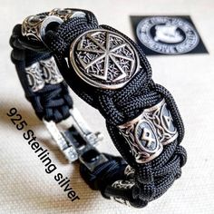 Black Viking protective amulet. Luxury gift for biker. Runic paracord bracelet.925 Sterling silver runes. Viking jewelry.Stylish handmade paracord bracelets for those who are always moving forward. These fashion accessories are made of extremely durable, scratch-resistant rope and original 925 Sterling silver beads runes.This bracelet contains 58 grams of pure 925 sterling silver. The castle weighs 14.74 grams, the 8 runes beads weighs 36 grams, and 1 round bead "KOLOVRAT" (black sun) weigh 8 gr Black Viking Jewelry For Outdoor, Black Viking Style Jewelry For Outdoor, Black Viking Style Outdoor Jewelry, Handmade Viking Style Black Bracelet, Handmade Black Sterling Silver Braided Bracelet, Adjustable Silver Paracord Bracelets, Handmade Black Braided Bracelets For Outdoor, Black Viking, Gift For Biker