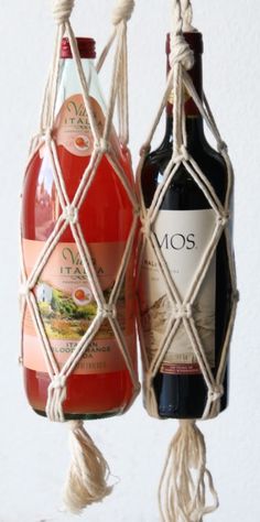 two bottles of wine are hanging from rope