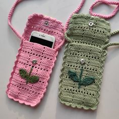 two crocheted cell phones cases sitting next to each other