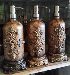 three soap dispensers are sitting on a shelf