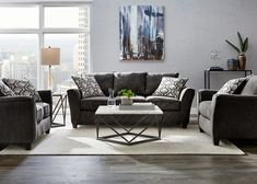 a living room with two couches and a coffee table in front of a large window