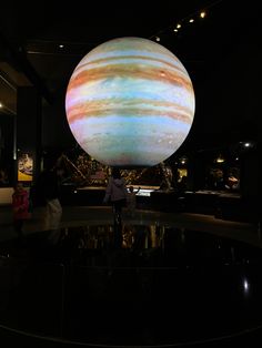 people are looking at the planets on display