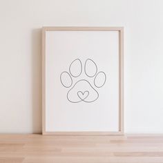 an animal's paw with a heart drawn on it in front of a white wall