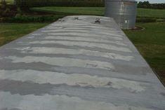 a long cement walkway in front of a farm