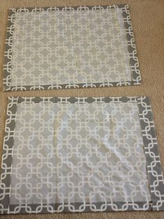 two pieces of fabric sitting on the floor next to each other, one has a gray and white pattern