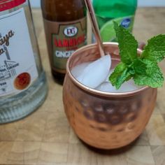 a copper cup filled with ice and mint