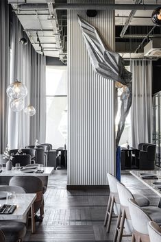 the interior of a restaurant with tables and chairs