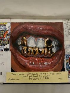 an altered photograph of a mouth with gold teeth and fangs on it's upper part