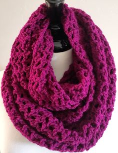 a purple crocheted scarf on top of a white mannequin