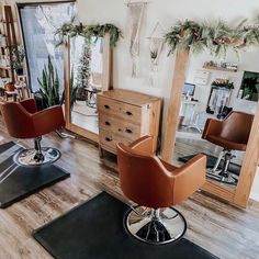 a hair salon with chairs and mirrors on the floor