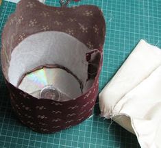 a close up of a piece of cloth with a cd in it and another object next to it