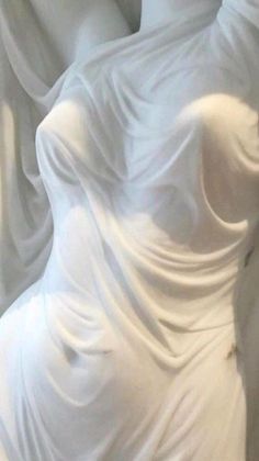 a white dress with flowing fabric on it