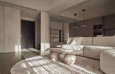 a living room filled with furniture next to a white couch and table on top of a hard wood floor