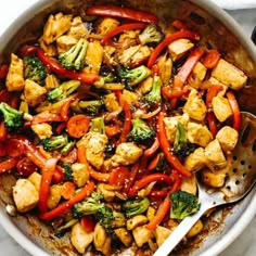 a pan filled with tofu, broccoli and red bell pepper stir fry