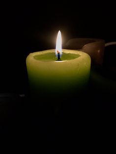 a lit candle sitting on top of a table