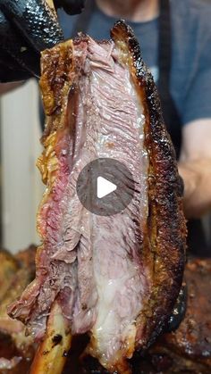 a man is cutting up some meat on the grill