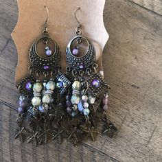 Czech & Swarovski Chandelier Earrings In Beautiful Brass Elements, Purple Swarovski Crystals And Iridescent Czech Green Nickel-free Purple Dangle Chandelier Earrings, Purple Crystal Metal Earrings For Party, Purple Metal Dangle Earrings, Purple Dangle Chandelier Earrings, Purple Dangle Metal Earrings, Purple Adjustable Drop Crystal Earrings, Purple Metal Chandelier Earrings For Gifts, Purple Metal Chandelier Earrings As Gift, Adjustable Purple Chandelier Drop Earrings