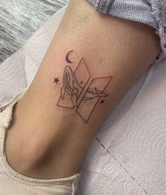 a woman's foot with a small tattoo on her left leg and a cross in the middle