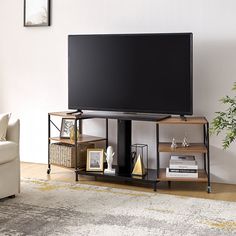 a flat screen tv sitting on top of a wooden stand