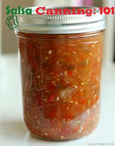 a jar filled with lots of food sitting on top of a table