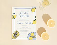 a lemon themed party is set up on a table with wine glasses and napkins