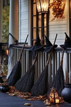 four brooms lined up on the front porch