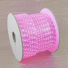 a spool of pink led rope light on a wooden surface with the words rope light above it