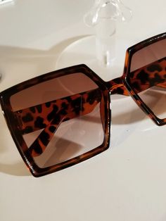 Vintage lightweight oversized square leopard print framed sunglasses.

2-day processing. Shipped in 4-7 days. Chic Leopard Print Sunglasses For Summer, Leopard Print Sunglasses With Tinted Lenses For Vacation, Leopard Print Sunglasses For Vacation, Chic Leopard Print Cat Eye Sunglasses For Summer, Leopard Print Tinted Sunglasses For Vacation, Square Sunglasses With Uv Protection For Vacation, Vacation Leopard Print Tinted Sunglasses, Trendy Leopard Print Sunglasses With Gradient Lenses, Summer Leopard Print Sunglasses With Tinted Lenses