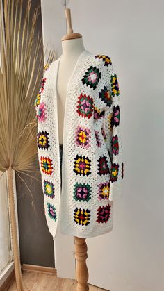 Bohemian White Outerwear With Granny Square, White Knitted Patterns For Fall, White Granny Square Cardigan For Spring, One Size White Crochet Sweater, White Knitting Pattern For Fall, Spring White Knitted Outerwear, Cream Crochet Outerwear For Winter, White Bohemian Patterns For Winter, White Crochet Outerwear For Fall