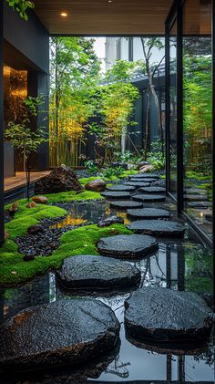 an outdoor garden with stepping stones and green moss growing on the ground in front of it