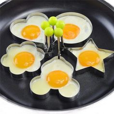 four fried eggs in the shape of stars on a frying pan