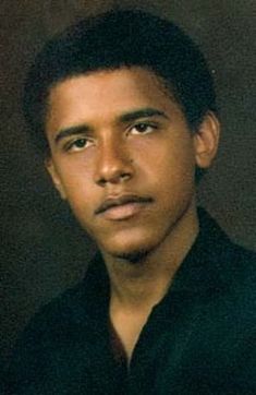 a young man in a black shirt is looking at the camera with an intense look on his face