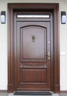 the front door is made of wood and has a decorative design on it's side