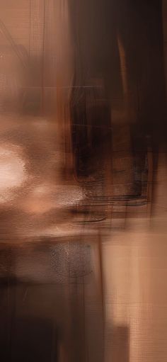 a blurry image of a clock on a table with an orange and brown background