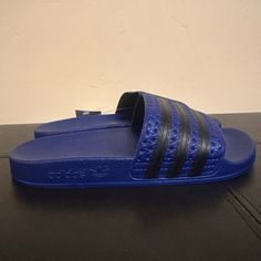 Adidas Adilette Boys Blue Slide Sandals Size 4 Adidas Sandals For Spring Swimming, Non-slip Blue Flip Flops For Swimming, Adidas Synthetic Sandals For Swimming, Adidas Synthetic Slide Flip Flops, Blue Non-slip Sandals For Summer, Blue Casual Slippers With Round Toe, Casual Blue Slippers With Round Toe, Adidas Non-slip Sport Sandals For Beach, Adidas Slides With Rubber Sole For Summer