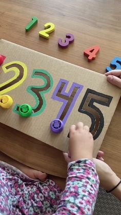 a child is playing with numbers and magnets