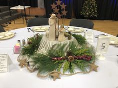 the table is set with christmas decorations and place settings