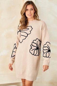 This whimsical sweater dress is an ode to simpler times. Delicate floral embroidery and scalloped accents evoke memories of carefree afternoons in a sun-dappled meadow. At the same time, its cozy knit fabric and effortless pullover silhouette keep you grounded in the present. Destined to become your go-to piece for lazy weekends and casual gatherings with friends, this lightweight wonder transitions gracefully. Whether you pair it with sneakers for a retro-inspired look or heeled booties for nig Spring Jacquard Knit Sweater With Relaxed Fit, Spring Jacquard Knit Sweater In Relaxed Fit, Cozy Cream Sweater Dress For Spring, Cozy Beige Sweater Dress For Spring, Casual Cream Sweater Dress For Spring, Casual Soft Knit Spring Dresses, Cozy Jacquard Knit Sweater For Spring, Fall Floral Applique Crew Neck Sweater, Oversized Knit Sweater Dress For Spring