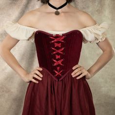 Our dark red velvet corset is the ultimate statement piece for those seeking a blend of luxurious elegance and historical charm. Perfect for renaissance faire costumes, Christmas parties, gothic or vampire outfits, or simply adding a bold, regal touch to your wardrobe, this corset is designed to flatter your silhouette while offering comfort and durability. Crafted from rich, 100% cotton deep red velvet, this corset features a classic lace-up front and back lacing for an adjustable fit, and synt Fitted Red Medieval Dress For Festivals, Velvet Corset Dress For Costume Party, Fitted Red Costume For Fantasy Events, Fitted Red Costumes For Fantasy Events, Gothic Boned Bodice For Costume Party, Red Corset Dress With Fitted Bodice For Costume Party, Gothic Fitted Bodice For Costume, Red Fitted Medieval Dress For Festivals, Fitted Medieval Style Corset For Fantasy Events