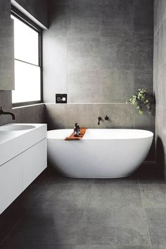 a white bath tub sitting next to a window