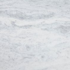 a white marble counter top textured with grey and white paint