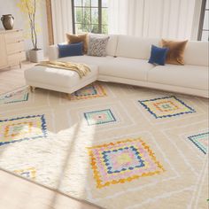 a white couch sitting on top of a rug in a living room