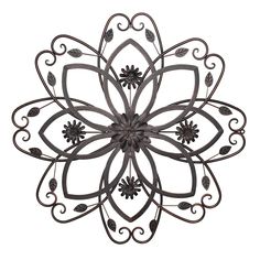 a metal wall decoration with flowers and leaves on the center, set against a white background