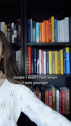 a woman standing in front of a bookshelf