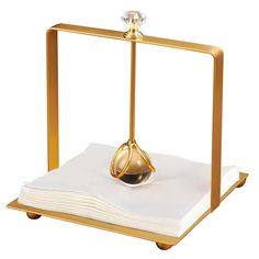 a gold plate with a napkin holder on it