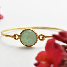 "Aventurine Round Gold Plated Bangle, 925 Sterling Silver Gold Plated Bangle, Handmade Bangle, Gift For Her, Openable Women Gemstone Bangle Stone - Aventurine Stone Size - 12mm Stone Shape - Round Materiel - 925 Sterling Silver  Metal Color - Gold Plated -------------------------------------- What birth month has Aventurine? Aventurine is the birthstone for August. What is aventurine stone used for? Aventurine has a number of bynames and trade names, including adventurine, adventurine quartz and Indian \"jade.\" Besides being used for beads and jewelry-making, aventurine is also carved into ornamental or décor pieces such as bowls, vases and statuettes. Is aventurine a lucky stone? Also known as \"The Stone of Opportunity\", Aventurine increases opportunity and attracts luck. From manifest Traditional Bangle Bracelets With Natural Stones, Traditional Bangle Bracelet With Natural Stones, Gold Gemstone Bangle For Festivals, Adjustable Round Gemstone Bangle, Ceremonial Gemstone Bangle Bracelet, Wholesale Silver Jewelry, Aventurine Stone, Gold Plated Bangles, Gemstone Bangle