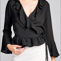 Ladies Fashion 3/4 Bell Sleeve Wrap W/Ruffle Side Tie Closure Flare Bottom Wool Dobby Woven Top. Fabric 100% Polyester Order25334 Spring Night Out Blouse With Ruffle Hem, Spring Ruffle Hem Blouse For Night Out, Ruffled 3/4 Sleeve Blouse For Work, Ruffled 3/4 Sleeve Tops For Work, Trendy Black Blouse With 3/4 Sleeves, Elegant Black Top With Ruffle Hem, Flirty Long Sleeve Blouse For Spring, Spring Black Blouse With Ruffle Hem, Chic Black 3/4 Sleeve Tops