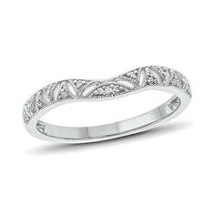 a white gold wedding band with diamonds on the sides and an intricate design in the middle