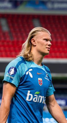 a soccer player is standing on the field