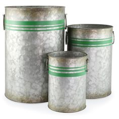 three metal buckets with green stripes on the side and one has a white lid